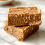 Close-up view of a square piece of Healthy Peanut Butter Protein Fudge on a white plate.