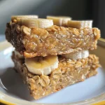 Close-up view of banana oat bars with chocolate chips, side angle.