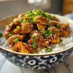 Close-up view of spicy chicken breasts garnished with chili flakes.