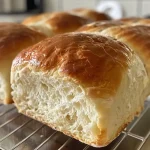 Close-up side view of a loaf of homemade bread with a golden crust.