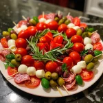 A close-up side view of a colorful Christmas Antipasto Wreath featuring fresh ingredients.