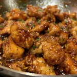 Close-up of juicy Garlic Brown Sugar Chicken pieces glistening in sauce.