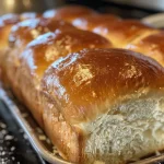 Close-up view of freshly baked homemade bread with a golden crust.