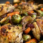 Close-up of a cooked chicken breast surrounded by colorful vegetables.