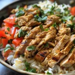 A bowl of chicken shawarma rice with vibrant spices and fresh herbs.