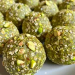 Close-up of juicy pistachio protein balls with a side view showcasing texture.