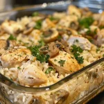 Juicy Chicken and Rice Casserole with a golden-brown top, served in a baking dish.