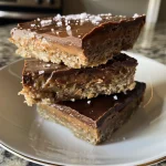 Close-up view of Salted Maple Protein Cookie Bars with a golden-brown surface and chocolate drizzle.