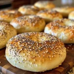 Close-up of freshly baked homemade everything bagels with a golden brown crust.