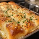 Close-up view of fluffy Garlic Butter Parmesan Rolls with melted cheese.