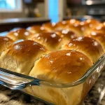 Freshly baked dinner rolls with a golden brown crust.