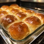 Close-up of soft honey whole wheat dinner rolls with a golden-brown crust.