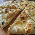 Close-up of a golden-brown yogurt flatbread with a fluffy texture.