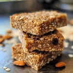 Close-up of chewy almond butter power bars with visible nuts and dried fruits.