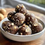 Close-up view of chocolate hazelnut energy balls on a plate, showcasing their rich, textured surface.