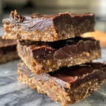 Close-up view of chocolate peanut butter protein bars with a smooth, glossy finish.