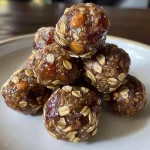 Close-up view of Date Nuts Energy Balls on a wooden surface, showcasing their textured surface.