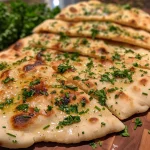 Close-up view of freshly baked Garlic and Herb Flatbread with a golden crust.