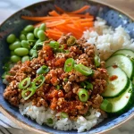 Close-up of a bowl filled with ground turkey, rice, and colorful vegetables.