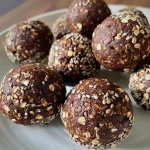 Close-up view of Healthy Chocolate Energy Balls on a textured surface.