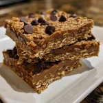 Close-up of No Bake Chocolate Oat Bars with a glossy chocolate topping.