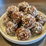 Close-up view of round energy balls made from dates and coconut.