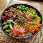 A colorful Tuna Sushi Bowl featuring rice, tuna, edamame, cucumber, avocado, and carrot.