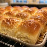 Close-up of golden, fluffy Cheddar Cheese Rolls with a glossy surface.