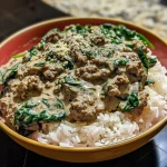 A close-up side view of creamy beef spinach rice, showcasing the rich texture and vibrant greens.