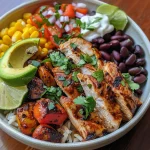 Close-up side view of a vibrant Mexican Chicken and Rice Bowl with colorful ingredients.