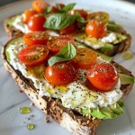 Close-up of avocado and cherry tomato cottage cheese toast on whole grain bread.