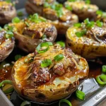 ['Close-up view of a BBQ stuffed potato topped with cheese and green onions.', 'Juicy BBQ stuffed potato with melted cheese and slices of green onion.', 'Side view of a BBQ stuffed potato, showcasing its filling and toppings.', 'Delicious BBQ stuffed potato with a generous layer of cheese and herbs.']