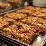 ['Close-up view of Cherry Almond Granola Bars with a texture-rich surface.', 'Side view of homemade Cherry Almond Granola Bars showcasing cherries and almonds.', 'Juicy Cherry Almond Granola Bars sliced and arranged on a clean surface.', 'Detailed shot of granola bars highlighting the almonds and dried cherries.']