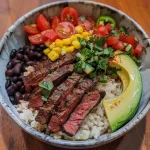 ['Close-up view of a Flank Steak Bowl featuring sliced steak and colorful toppings.', 'Side view of a delicious Flank Steak Bowl with vibrant ingredients like avocado and tomatoes.', 'Juicy Flank Steak Bowl showcasing ingredients arranged in a bowl, including rice and beans.', 'Detailed shot of a Flank Steak Bowl filled with flank steak, corn, and fresh cilantro.']