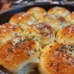 ['Close-up view of golden-brown Garlic Parmesan Skillet Rolls with a glossy buttery glaze.', 'Side view of fluffy, cheesy Garlic Parmesan rolls in a skillet, sprinkled with herbs.', 'Delicious Garlic Parmesan Skillet Rolls arranged in a cast iron skillet, glistening with melted butter.', 'A tempting close-up of homemade Garlic Parmesan rolls, showcasing their soft texture and herb topping.']