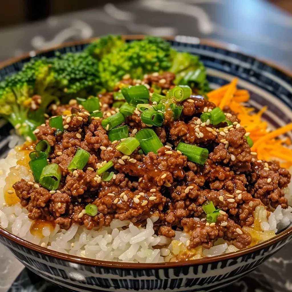 ['Close-up of a juicy Ground Beef Hot Honey Bowl with colorful vegetables.', 'Side view of a Ground Beef Hot Honey Bowl featuring ground beef and fresh greens.', 'Delicious Ground Beef Hot Honey Bowl garnished with sesame seeds and scallions.', 'Appetizing Ground Beef Hot Honey Bowl with a vibrant mix of ingredients.']