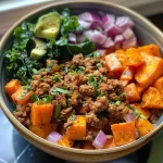 ['A colorful bowl filled with ground turkey, diced sweet potatoes, and fresh greens.', 'Close-up view of a Ground Turkey Sweet Potato Bowl with avocado slices on top.', 'A side view of a nutritious meal featuring ground turkey and sweet potatoes.', 'An appetizing bowl showcasing ground turkey, sweet potatoes, and chopped vegetables.']