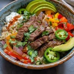 ['A close-up view of a high protein keto steak fajita bowl, featuring vibrant bell peppers and avocado.', 'Side shot of a keto steak fajita bowl with juicy steak, fresh vegetables, and creamy toppings.', 'Detailed image of a protein-packed fajita bowl with colorful peppers, onions, and garnishes.', 'A visually appealing keto steak fajita bowl filled with sliced steak, riced cauliflower, and various toppings.']