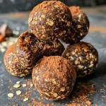 ['Close-up of Mocha Espresso Protein Balls showcasing a chewy texture and glossy surface.', 'Side view of round Molcha Espresso Protein Balls glistening with a cocoa dusting.', 'Delicious Mocha Espresso Protein Balls arranged on a wooden surface, emphasizing their rich color.', 'Juicy Mocha Espresso Protein Balls with visible chocolate and coffee ingredients in a natural setting.']