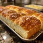 ['Close-up view of a slice of golden-brown potato bread, showcasing its crust and fluffy interior.', 'Side view of freshly baked potato bread, emphasizing its soft texture and appetizing appearance.', 'Detailed shot of potato bread, highlighting its crispy crust and airy crumb structure.', 'Close-up image of a slice of potato bread, revealing the moist and inviting texture inside.']