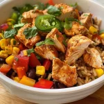 ['Close-up view of a Southwest Chicken and Rice Bowl with vibrant ingredients.', 'A side view of a colorful bowl filled with chicken, rice, beans, and vegetables.', 'Detailed shot of a Southwest Chicken and Rice Bowl showcasing fresh ingredients.', 'Close-up image of a deliciously arranged bowl of Southwest Chicken and Rice.']