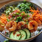 ['A side view of a spicy shrimp rice bowl garnished with vegetables.', 'Close-up image of a vibrant shrimp rice bowl with diced cucumbers and edamame.', 'Juicy shrimp served over rice with colorful vegetables in a bowl.', 'A delicious shrimp rice bowl featuring shrimp, carrots, and a drizzle of sriracha mayo.']