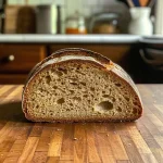 ['Close-up side view of a loaf of Sweet Sourdough Bread showcasing its golden crust and soft interior.', 'Juicy Sweet Sourdough Bread with a golden-brown crust, highlighting its texture and ingredients.', 'Soft and tangy Sweet Sourdough Bread, displayed from the side to show the fluffy crumb and crust.', 'Side view of a freshly baked Sweet Sourdough Bread, capturing its inviting color and moist appearance.']