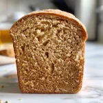 ['Close-up of a slice of yeast-free whole wheat honey bread with a golden crust and a soft texture.', 'Side view of freshly baked whole wheat honey bread, showcasing its rustic appearance and sprinkle of sunflower seeds.', 'Juicy whole wheat honey bread displayed on a wooden board, highlighting its crumb and crust.', 'A warm loaf of yeast-free whole wheat honey bread with a light glaze of honey, resting on a kitchen countertop.']