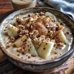 ['A close-up of a colorful apple smoothie bowl topped with fruits and nuts.', 'Side view of an apple smoothie bowl with vibrant toppings and a creamy texture.', 'Juicy apple smoothie bowl garnished with almond butter and granola.', 'Refreshing apple smoothie bowl featuring chopped fruits and a sprinkle of cinnamon.']