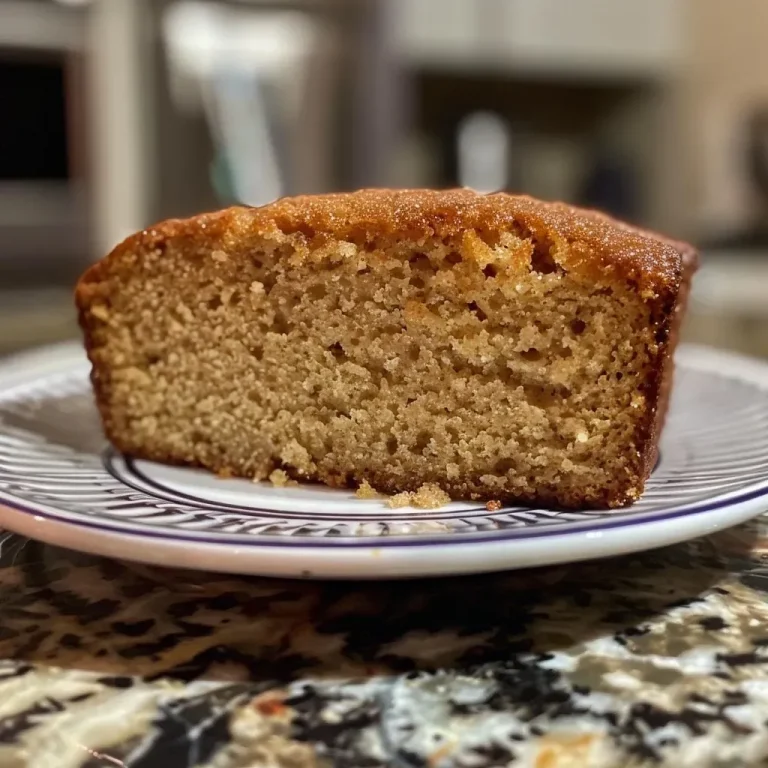 ['Close-up side view of a moist cinnamon sugar loaf cake showcasing a golden-brown crust.', 'A delicious slice of cinnamon sugar loaf cake with a crumbly texture and sprinkled sugar on top.', 'Side angle of a freshly baked cinnamon sugar loaf cake highlighting its fluffy interior and glaze.', 'Juicy cinnamon sugar loaf cake captured from the side, emphasizing its rich color and sugar sprinkle.']