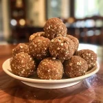 ['Close-up view of juicy No Bake Gingerbread Balls made with almond and oat flour.', 'Side view of a cluster of No Bake Gingerbread Balls, showcasing their rich texture.', 'Detailed image of No Bake Gingerbread Balls with spices visible, highlighting ingredients.', 'Mouth-watering presentation of No Bake Gingerbread Balls, emphasizing their homemade appeal.']