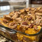 ['Close-up view of a Pumpkin French Toast Casserole with a golden-brown crust and visible pecans.', 'Side view of a deliciously baked Pumpkin French Toast Casserole, showcasing its fluffy texture and pumpkin color.', 'Detailed shot of a Pumpkin French Toast Casserole, featuring layers of bread and a sprinkle of pecans on top.', 'Close-up image of a slice of Pumpkin French Toast Casserole with a creamy custard filling and a crispy topping.']