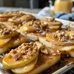 ['Close-up view of Sheet Pan Ricotta Pancakes topped with sliced pears.', 'Side view of golden-brown Sheet Pan Ricotta Pancakes on a baking sheet.', 'Juicy Sheet Pan Ricotta Pancakes garnished with pears and a dusting of powdered sugar.', 'Appetizing Sheet Pan Ricotta Pancakes displayed on a rustic wooden table.']