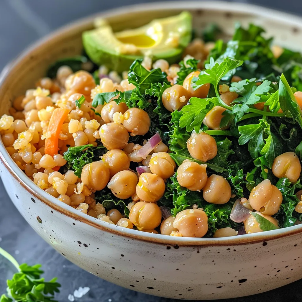['Close-up side view of a vibrant Kale and Chickpea grain bowl with colorful vegetables.', 'Delicious grain bowl featuring kale, chickpeas, and fresh vegetables, captured in detail.', 'A filling bowl of kale, chickpeas, and grains, showcasing its fresh ingredients.', 'Colorful Kale and Chickpea bowl filled with rich textures and fresh greens from a side angle.']